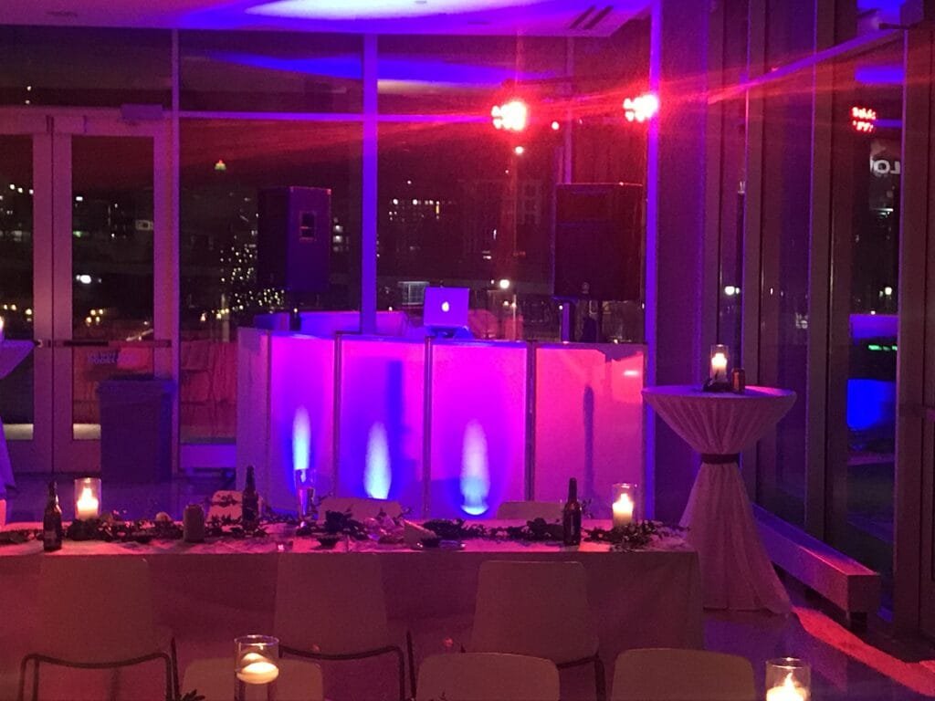 DJ booth with colorful lighting at a wedding reception